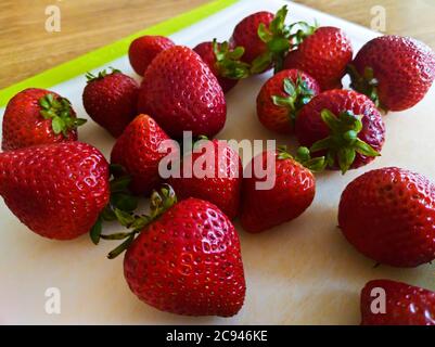 A bunch of fresh strawberries on a board Stock Photo