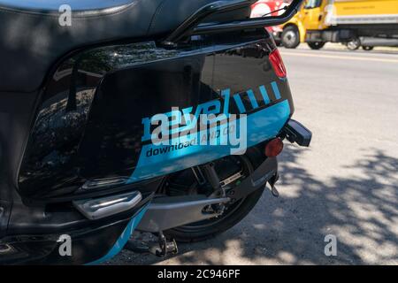 New York, NY - July 28, 2020: Revel moped parked on the street of Manahttan. Company suspended its service amid safety concerns Stock Photo