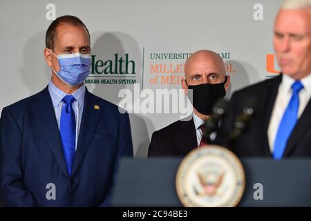 Miami, Florida, USA. 27th July, 2020. Rep. Mario Díaz-Balart, Dr. Stephen Hahn, FDA Commissioner and U.S. Vice President Mike Pence participates during a press conference to mark the beginning of Phase III trials for a Coronavirus vaccine at the University of Miami Miller School of Medicine, Don Soffer Clinical Research Center on July 27, 2020 in Miami, Florida. The Vice President participate in a roundtable with Florida Gov. Ron DeSantis, FDA Commissioner, university leadership and researchers on the progress of a Coronavirus vaccine. Credit: Mpi10/Media Punch/Alamy Live News Stock Photo