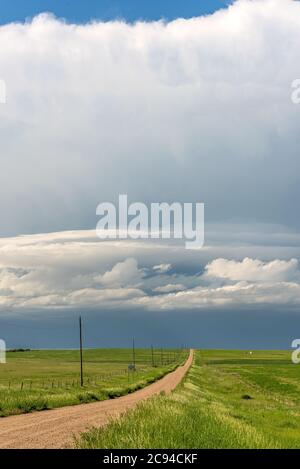 Panorama of a massive storm system, which is a pre-tornado stage, passes over a grassy part of the Great Plains Stock Photo