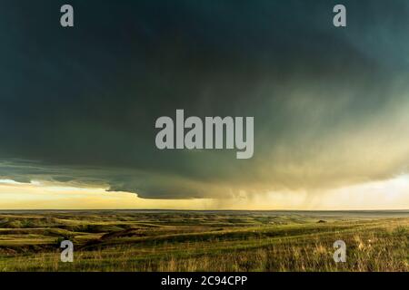 Panorama of a massive mesocyclone weather supercell, which is a pre-tornado stage, passes over a grassy part of the Great Plains Stock Photo