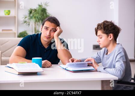 Father and disabled son in the education concept Stock Photo