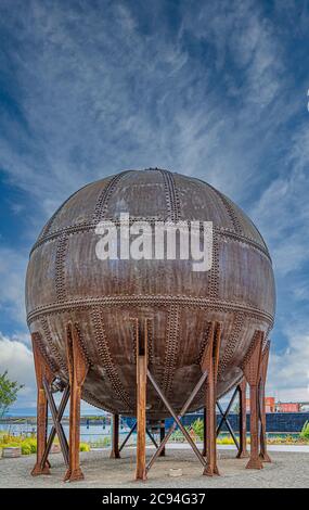 Round Rusty Tank with Rivets on Sky Stock Photo