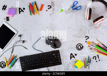 School supplies with tablet and computer keyboard on white table. Back to school concept. Stock Photo