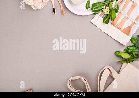 Eco friendly, disposable, recyclable, compostable tableware. Toothbrush, plate, cutlery, bag made of eco materials. Carering of nature and recycling concept. Copy space. Flat lay. Top view. Stock Photo