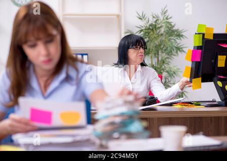 Two employees and excessive work in the office Stock Photo