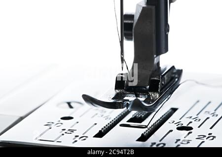 6 - Pure white plain background, dark silhouette of ready to go sewing machine, leading left to right with copy space. Stock Photo
