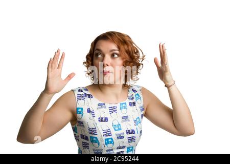 Portrait of afraid a young redheaded overweight girl on a white background isolated Stock Photo