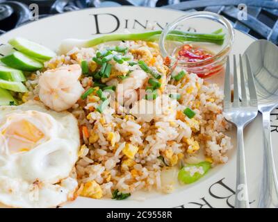 Fried rice with shrimps, the traditional Thai food with fried egg and prik nam pla, fish sauce with chili pepper, at a restaurant in Pattaya, Thailand Stock Photo