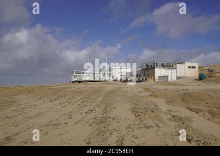 North Sea with a sandy beach in the Netherlands in the storm with a beach pavilion. Bergen aan zee, Netherlands, March Stock Photo