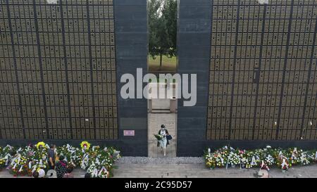 Beijing, China. 28th July, 2020. A woman holding flowers walks past memorial walls in Tangshan, north China's Hebei Province, in this aerial photo taken on July 28, 2020, the 44th anniversary of the 1976 Tangshan Earthquake. Credit: Dong Jun/Xinhua/Alamy Live News Stock Photo