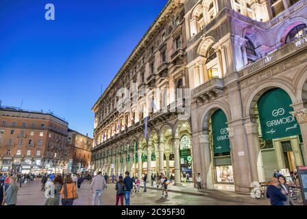 MILAN, ITALY - SEPTEMBER 2015: Tourists and locals enjoy night life in Duomo Square, city tourist center Stock Photo