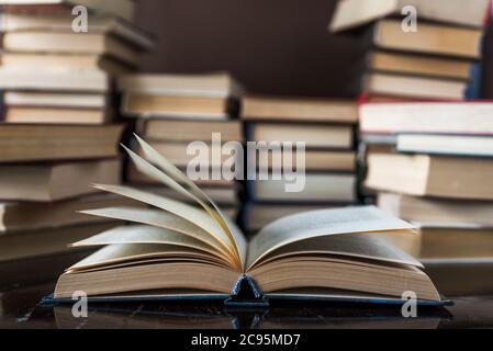 Stack of books background. a lot of books. A stack of books of different thicknesses in the library, a pile of old books, back to school Stock Photo