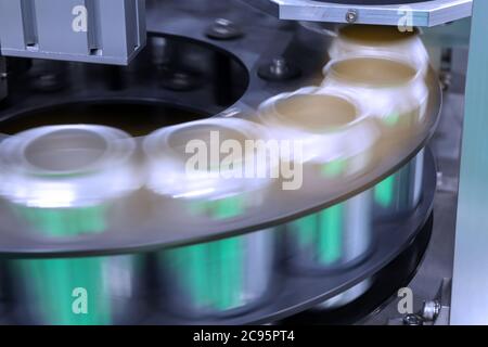 empty new aluminum cans for drink process are moving in factory line on conveyor belt machine at beverage manufacturing. food and beverage industrial Stock Photo