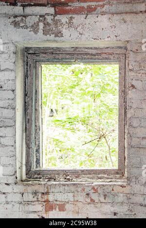 Window opening of an abandoned house without glass Stock Photo