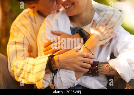 Close-up of two girlfriends embracing each other while resting outdoors Stock Photo