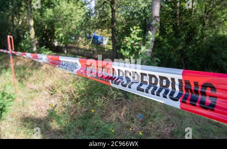 Seelze, Germany. 29th July, 2020. Police barrier tape hangs from an allotment garden in the Hannover region. In the case of the missing little Maddie McCann, police are continuing the excavation work in an allotment garden near Hanover. Credit: Julian Stratenschulte/dpa/Alamy Live News Stock Photo