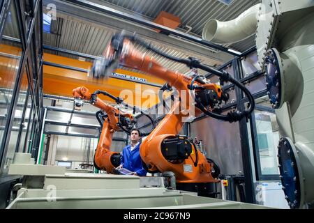 Dortmund, North Rhine-Westphalia, Germany - High Technology in the Ruhr Area. A technician from carat robotic innovation GmbH programs an articulated Stock Photo
