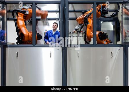 Dortmund, North Rhine-Westphalia, Germany - High Technology in the Ruhr Area. A technician from carat robotic innovation GmbH programs an articulated Stock Photo