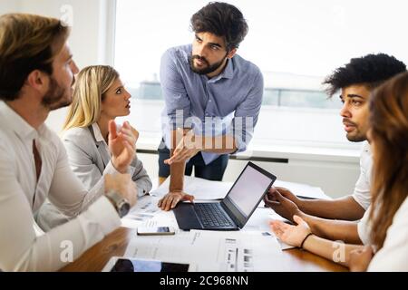 Business team people discussing documents and ideas at meeting Stock Photo
