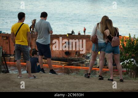 Locals watch salvaging of wrecked ship in Odessa Ukraine. Stock Photo