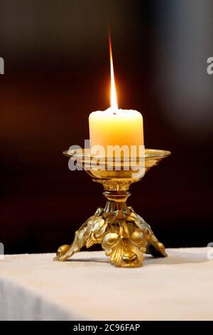 Church candel on altar.  Sallanches. France. Stock Photo