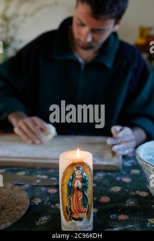 Young man making dough in Eure, France. Stock Photo