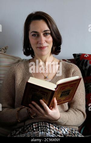 Kahina Bahloul, the first woman imam in France, holding a Kuran in paris. Stock Photo