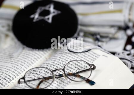 Open Torah, kippah, tallit  and pair of glasses. France. Stock Photo