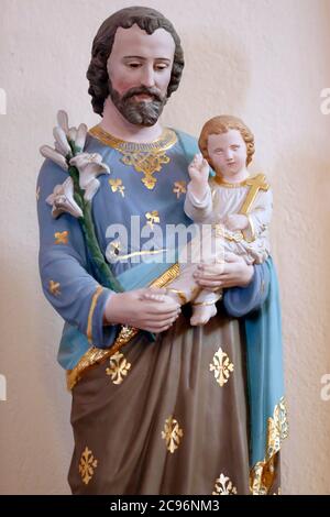 Saint Pierre aux Liens ( (Saint Peter in Chains ) church. Saint Joseph and infant Jesus.  La Giettaz. France. Stock Photo