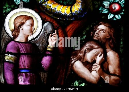 Basilica of Our Lady of Geneva.  Stained glass window. Adam and Eve driven from Paradise. Geneva. Switzerland. Stock Photo