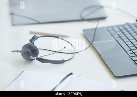 Close-up of headphones with laptop on the table the working day is over Stock Photo