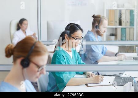 Medical team using headsets while working at their workplace in medical call center Stock Photo