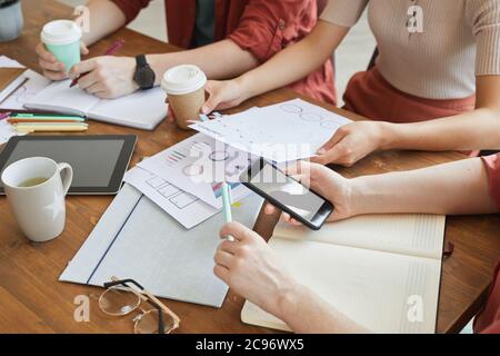Close-up of business team sitting at the table and planning work together during business meeting at office Stock Photo