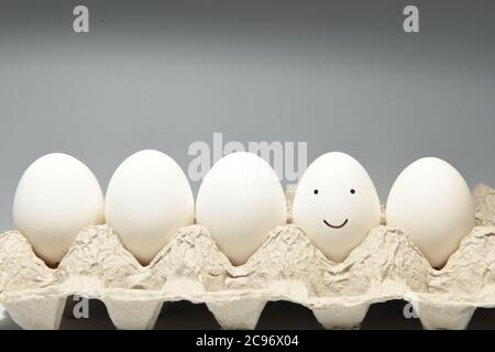 Sweet smiley face emoji on an egg shell Stock Photo