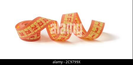 Roll of yellow orange measuring tape with centimeters isolated on white background. Concept of healthy eating, body weight control, weight loss and sl Stock Photo