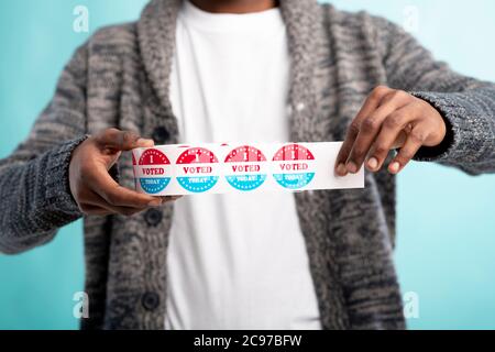 African Citizen of America holding Stickers I vote today Stock Photo