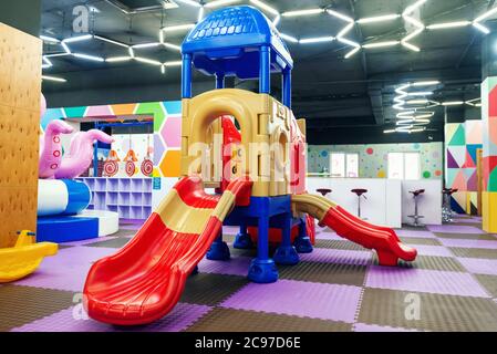 Odessa, UKRAINE - July 28, 2020: Focus on empty multicolor slides in children's entertainment centre Stock Photo