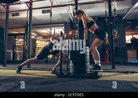 Beautiful Sporty Woman Doing Power Fitness Exercise At Sport Gym