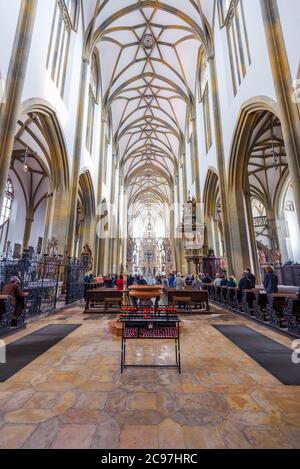 AUGSBURG, GERMANY - SEPTEMBER 29, 2013: Worshippers in Basilica of SS. Ulrich and Afra, Augsburg. Stock Photo