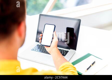 Cropped shot of a businessman using a mobile phone at his desk in an office. White fullscreen. Stock Photo