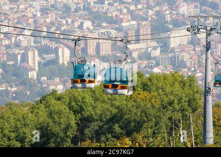 Cable car elevator with city view to Skopje in background. Gondola cabin lift from Vodno mountain. Republic of North Macedonia.