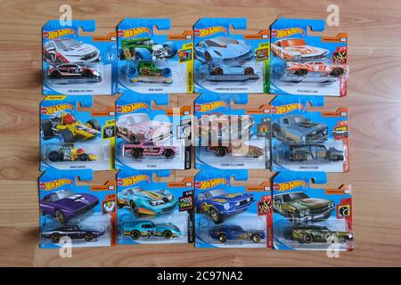 Istanbul, Turkey - July 29, 2020 : 12 Hot Wheels die cast toy cars in blisters on wooden floor from directly above view . Stock Photo