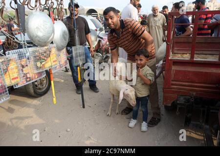 Khan Younis, Gaza. 29th July, 2020. Gaza, Palestine. 29th July 2020. A vendor waits for customers at a livestock market in preparation for the upcoming Muslim Eid al-Adha holiday in Deir el-Balah, central Gaza Strip, Wednesday, July 29, 2020. Muslims around the world celebrate Eid al-Adha to mark the end of the Haj by slaughtering sheep, goats, cows and camels to commemorate Prophet Abraham's willingness to sacrifice his son Ismail on God's command. Photo by Ismael Mohamad/UPI Credit: UPI/Alamy Live News Stock Photo