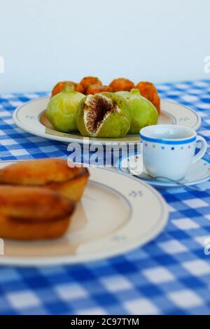 Breakfast in Salento, with typical products of the southern Italian tradition: Prickly pears, figs and Pasticciotto with cream on ceramic plates and w Stock Photo