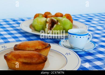 Breakfast in Salento, with typical products of the southern Italian tradition: Prickly pears, figs and Pasticciotto with cream on ceramic plates and w Stock Photo