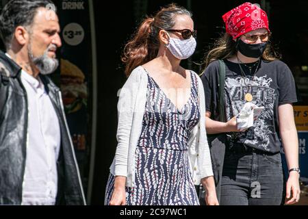 WIMBLEDON LONDON 29 July, 2020. People shopping in Wimbledon town centre wearing protective facemasks against covid-19 infections. The government has predicted the United Kingdom will be facing a second coronavirus wave in two weeks amid fears the economy will go into lockdown again.  Prime Minister Boris Johnson has expressed concerns over  new outbreaks 'bubbling up', both at home and abroad.  Credit: amer ghazzal/Alamy Live News Stock Photo