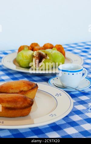 Breakfast in Salento, with typical products of the southern Italian tradition: Prickly pears, figs and Pasticciotto with cream on ceramic plates and w Stock Photo