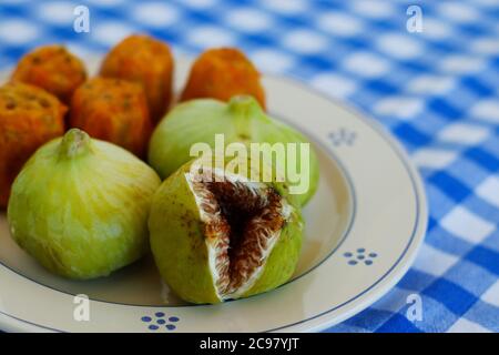 Breakfast in Salento, with typical products of the southern Italian tradition: Prickly pears, figs and Pasticciotto with cream on ceramic plates and w Stock Photo