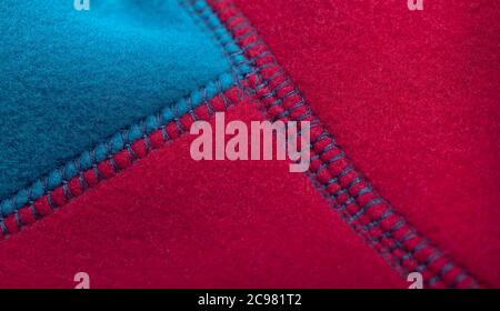 Blue red fleece jacket seams, close up photo Stock Photo